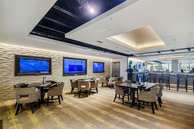 carpeted dining space with indoor bar