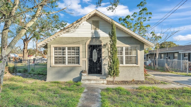 bungalow-style house with a front yard