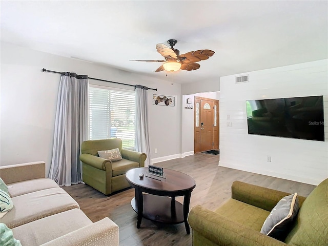 living room featuring hardwood / wood-style flooring and ceiling fan