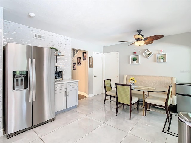 dining room with light tile patterned floors and ceiling fan