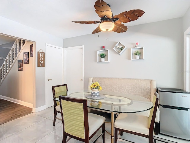 dining space with ceiling fan and light tile patterned floors