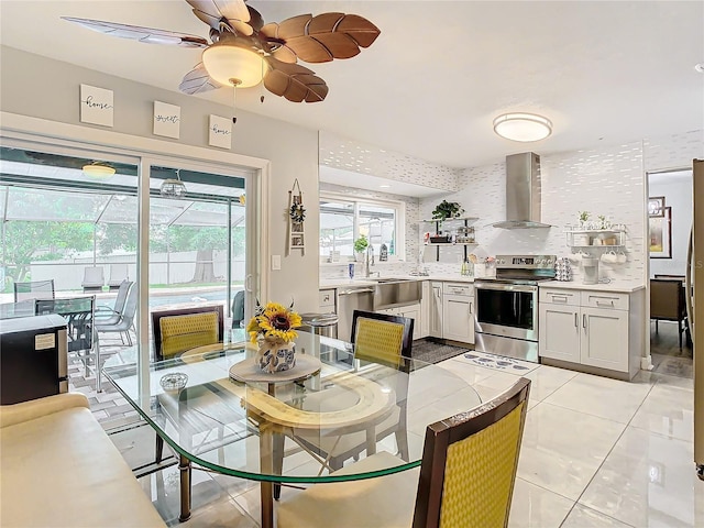 tiled dining room with sink and ceiling fan