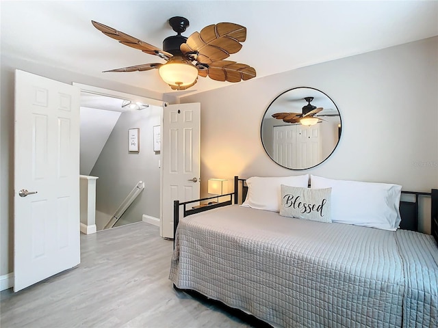 bedroom with ceiling fan and light hardwood / wood-style flooring