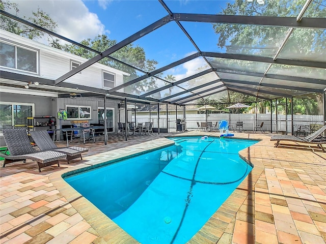 view of pool featuring a patio and glass enclosure