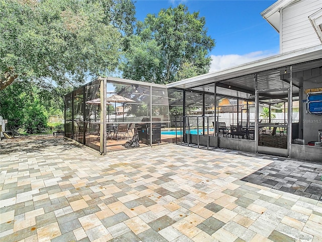 view of patio / terrace with a fenced in pool and glass enclosure