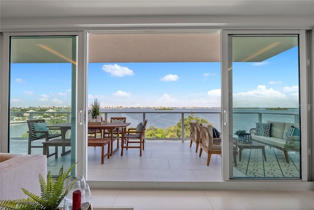 interior space with tile patterned flooring and a water view