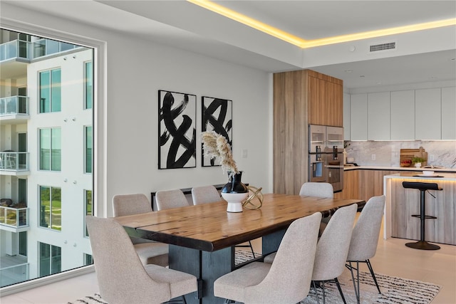 dining room featuring a raised ceiling