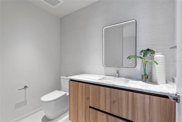 bathroom with vanity and toilet