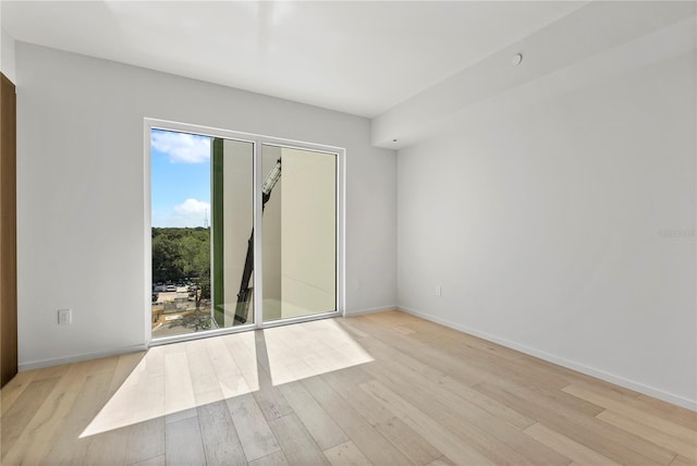 spare room featuring light wood-type flooring