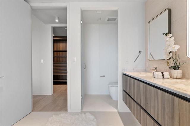 bathroom featuring vanity and toilet