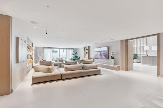 living room featuring floor to ceiling windows and light tile patterned floors