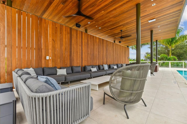 exterior space with wooden ceiling, expansive windows, ceiling fan, and wood walls