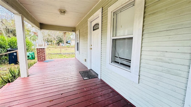 wooden terrace featuring covered porch