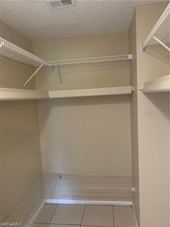 spacious closet featuring light tile patterned flooring