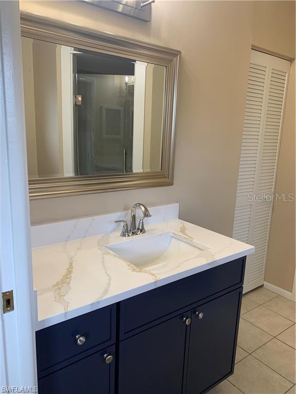 bathroom with tile patterned floors and vanity