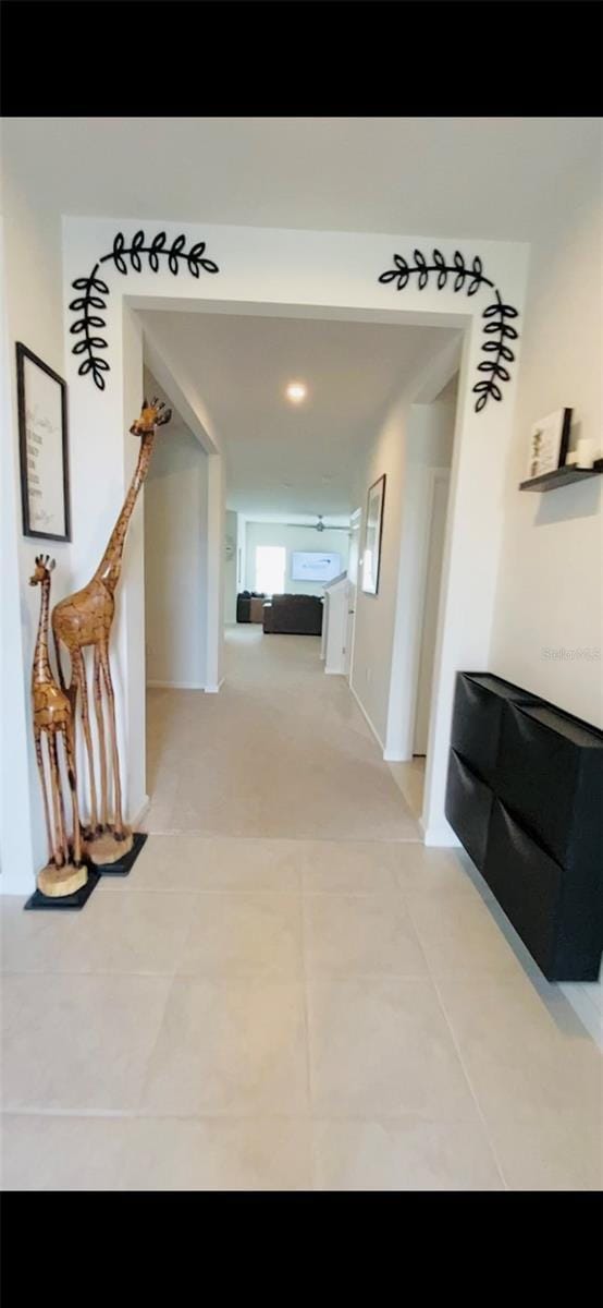 hallway featuring light tile patterned floors