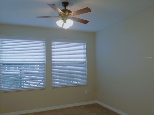 empty room with ceiling fan and carpet flooring