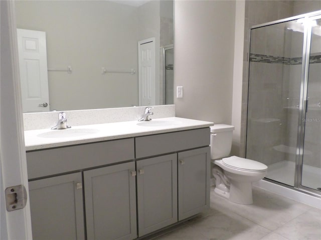 bathroom featuring vanity, an enclosed shower, and toilet