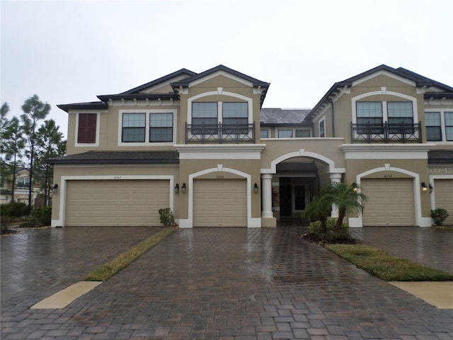 view of front facade with a garage and a balcony