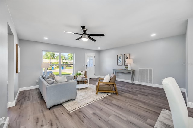 living room featuring ceiling fan and wood-type flooring