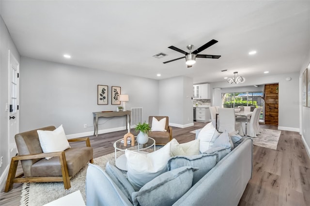 living room featuring ceiling fan and light wood-type flooring