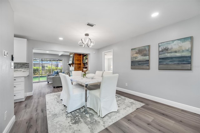 dining room featuring an inviting chandelier and light hardwood / wood-style floors