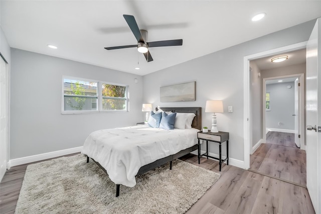 bedroom with ceiling fan and light hardwood / wood-style floors