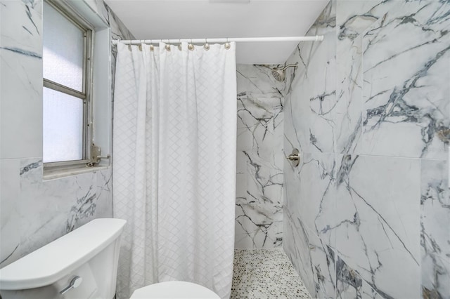 bathroom with walk in shower, tile walls, and toilet