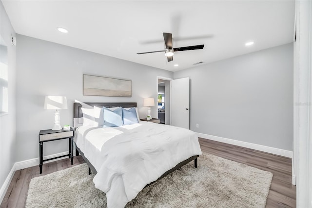 bedroom with hardwood / wood-style flooring and ceiling fan