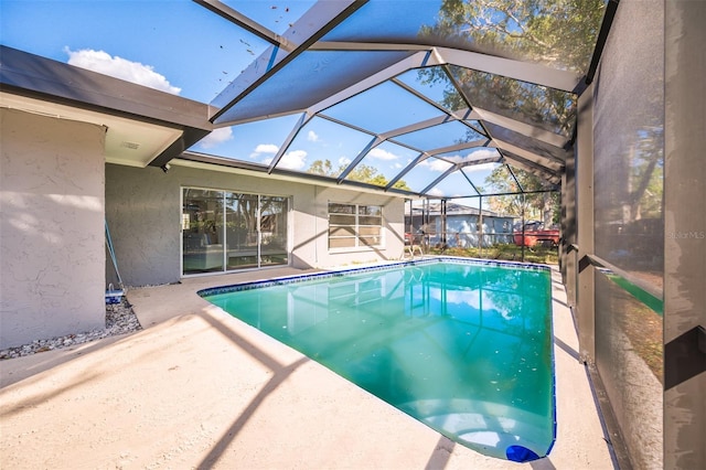 view of pool featuring a lanai and a patio