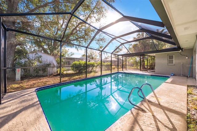 view of swimming pool with a patio area and glass enclosure