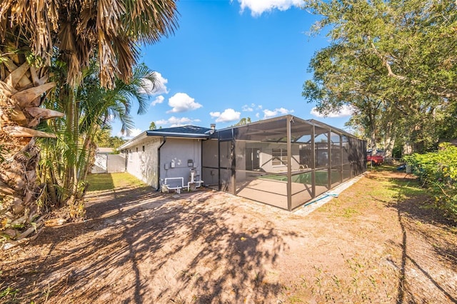 rear view of house featuring a lanai and a patio