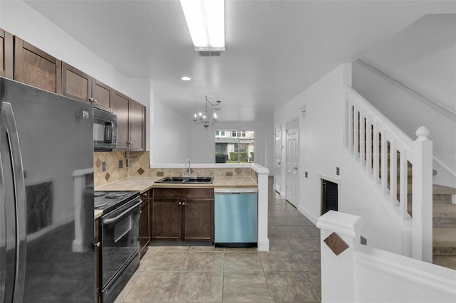 kitchen with sink, tasteful backsplash, dark brown cabinets, kitchen peninsula, and black appliances