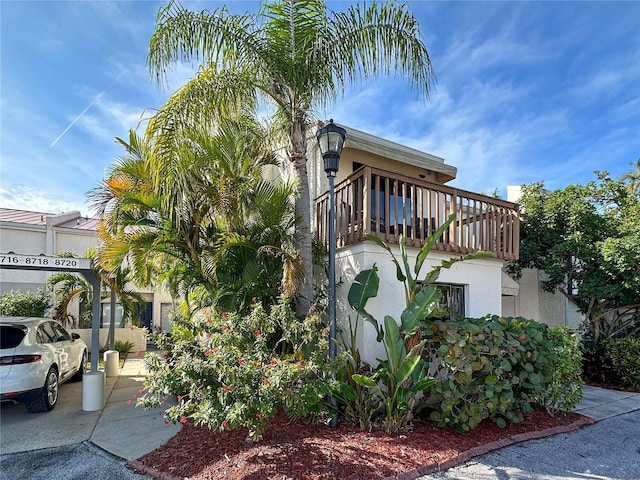 view of side of home with a balcony