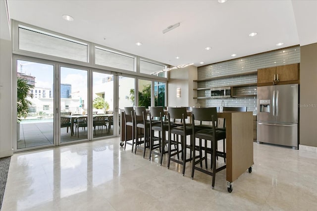 dining space featuring a wall of windows