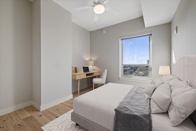 bedroom with ceiling fan and light wood-type flooring