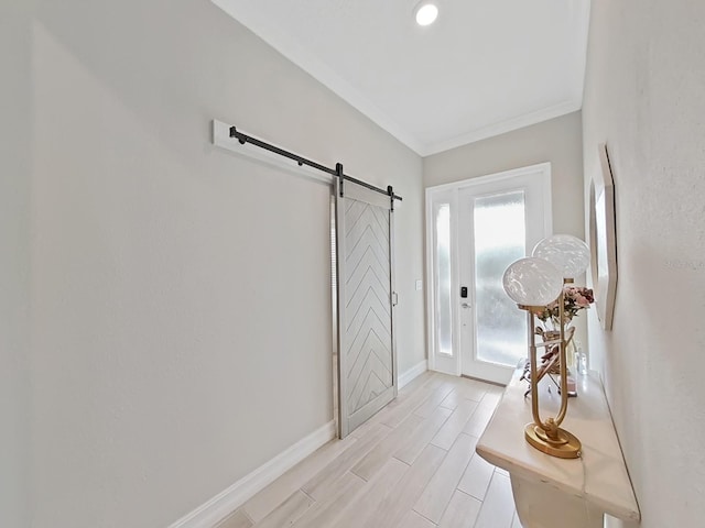 entrance foyer featuring crown molding and a barn door