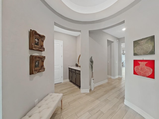 corridor with light hardwood / wood-style flooring