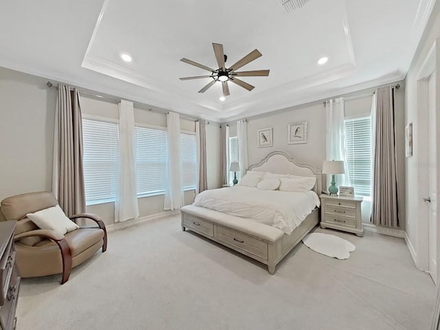 carpeted bedroom featuring crown molding, ceiling fan, and a tray ceiling