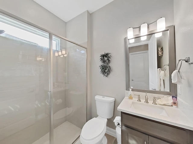 bathroom with an enclosed shower, vanity, and toilet