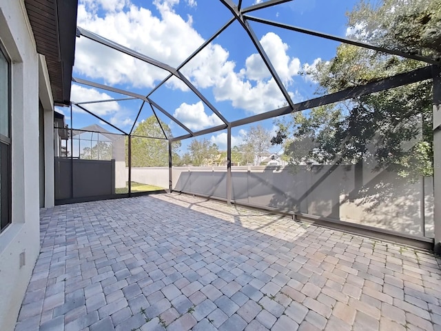 view of patio featuring a lanai