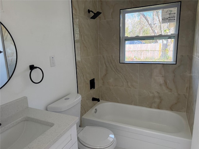 full bathroom with vanity, tiled shower / bath combo, and toilet