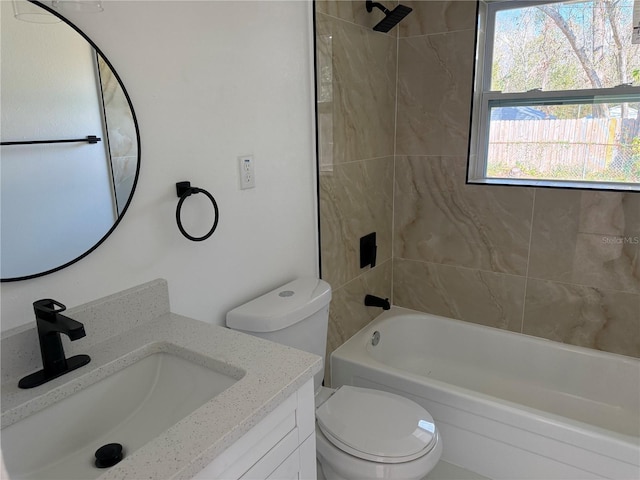 full bathroom featuring vanity, tiled shower / bath combo, and toilet