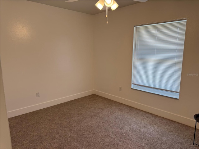 empty room with ceiling fan and carpet flooring