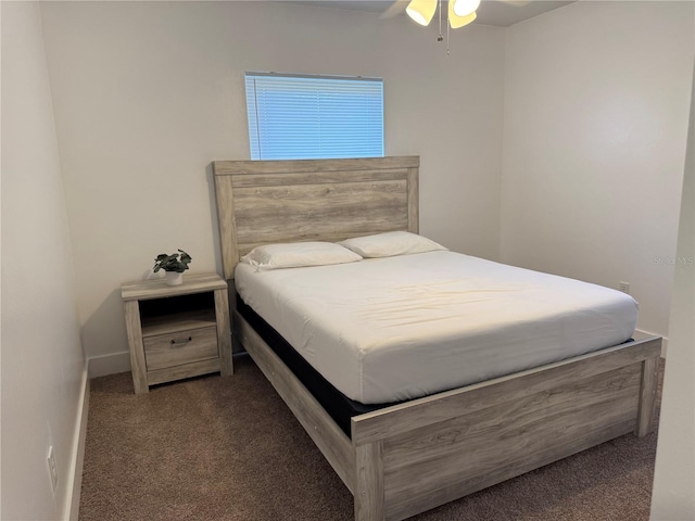 bedroom featuring dark carpet