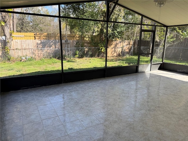 unfurnished sunroom with lofted ceiling