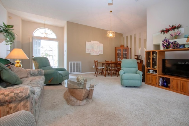 living room with high vaulted ceiling and carpet flooring