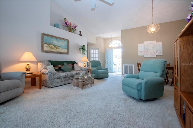 living room featuring high vaulted ceiling and carpet