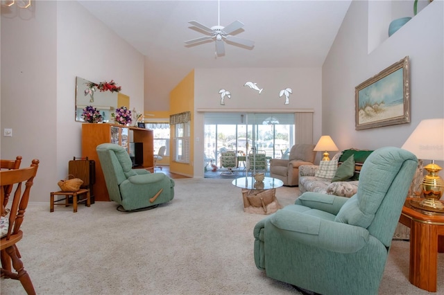 living room with a high ceiling, carpet flooring, and ceiling fan