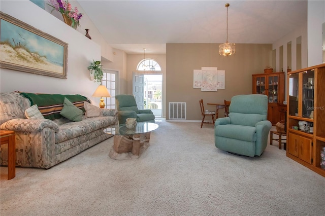 carpeted living room featuring high vaulted ceiling